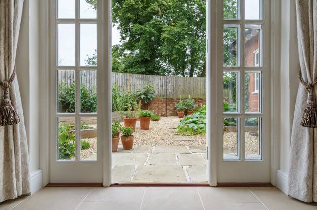 French doors opening out into a garden from a living room