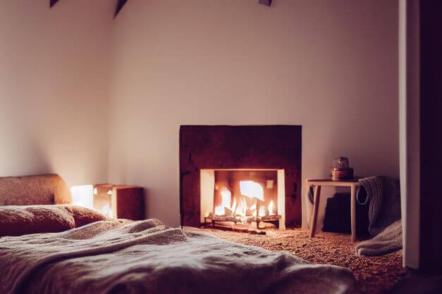 A bedroom with fireplace