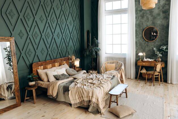 Upcycled bedroom furniture in dark green room