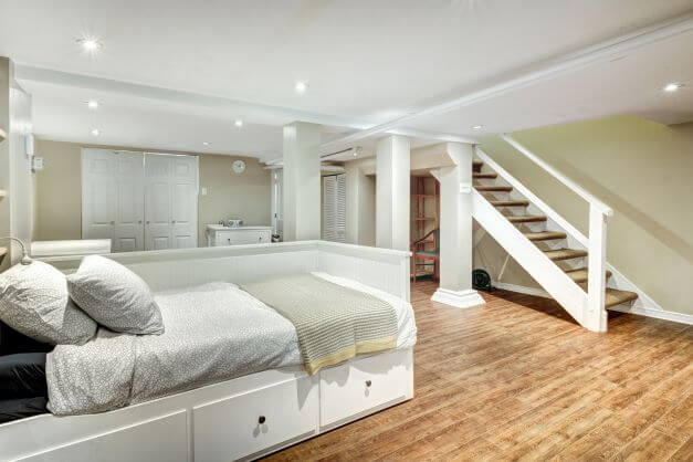 A light basement bedroom with internal stairway