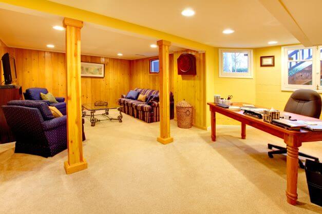 A basement home office with table and chairs