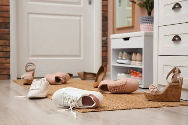 Messy shoes strewn over floor