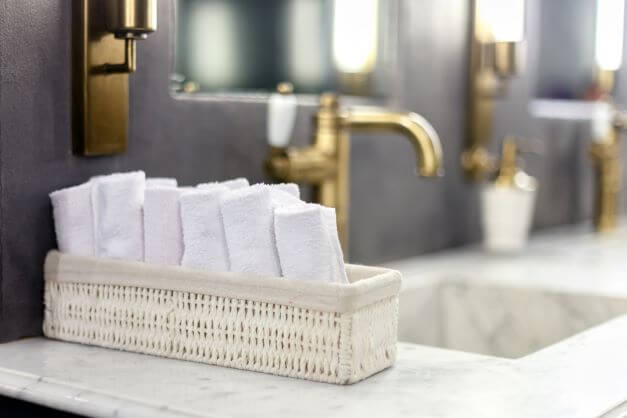 Small Bathroom Ideas: Tips On How To Maximise Space 3 A small basket with flannels next to sink in a small bathroom