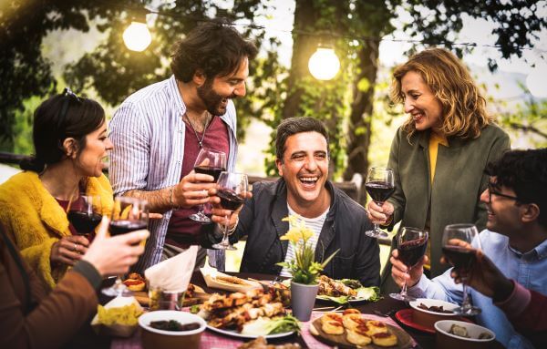 People gathered around a dining table outside